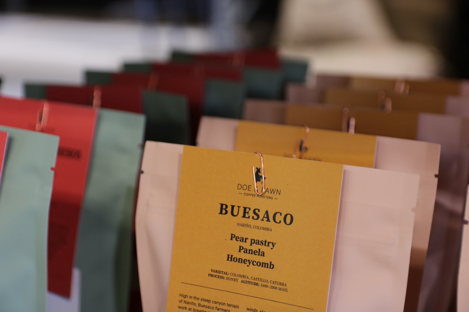 Doe & Fawn coffee bags lined up at the roastery
