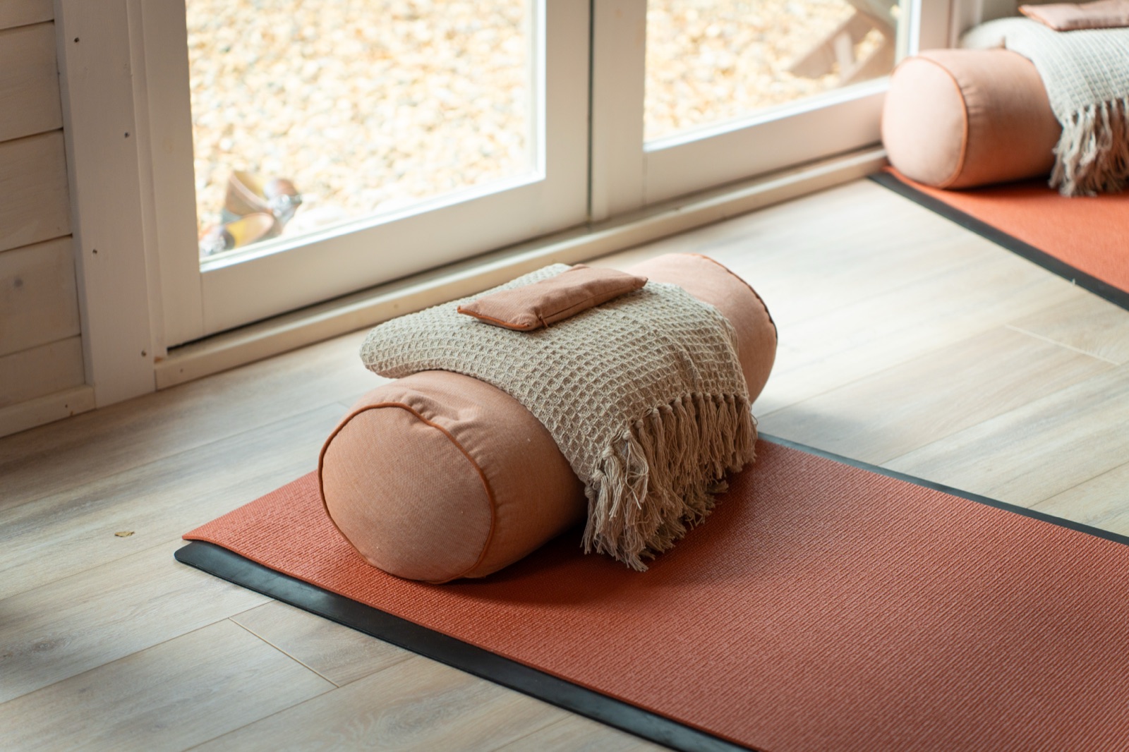 Bolster on a yoga mat beside the garden doors
